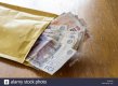 brown-envelope-stuffed-full-of-cash-HYAF9R.jpg