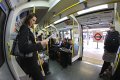 Woman standing in London Tube fisheye Canon 40D 7244.JPG