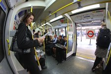 Woman standing in London Tube fisheye Canon 40D 7244.JPG